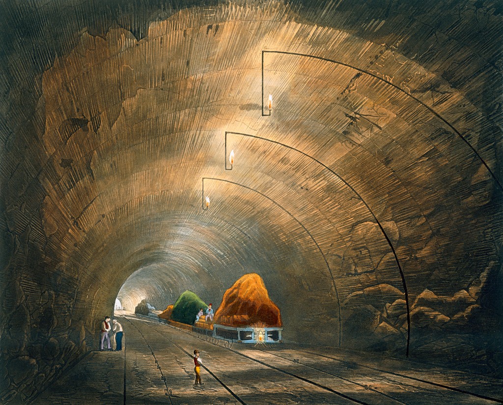 An 1833 coloured print showing railway wagons, workers and visitors inside the illuminated Wapping Tunnel